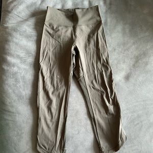 Olive green cropped lululemon leggings with mesh back panels